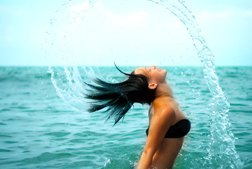 splashes. Girl in the sea