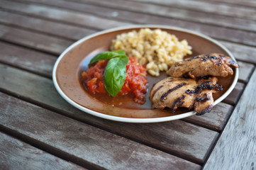 Grilled chicken with basil leaves