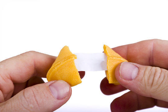 Fortune Cookie in hands with blank paper
