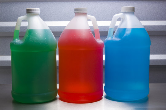 Gallon containers with colored liquid