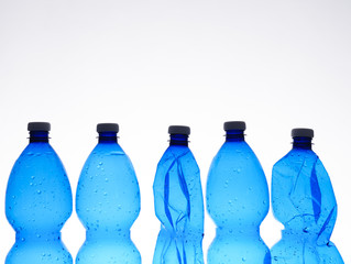 bottles of blue plastic in row