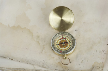 Retro compass on paper background