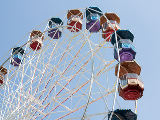 Colorfull big wheel over clear blue sky.