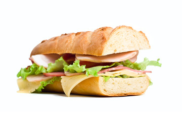 half of long baguette sandwich with lettuce, tomatoes, ham, turk