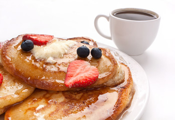 stack of pancakes with syrup and fruit