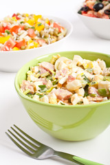 Egg salad in a green bowl with fork