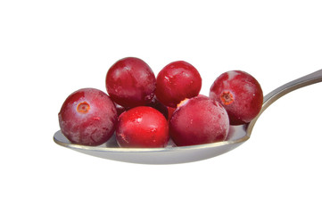 Spoon of fresh frozen cranberries isolated on white, macro