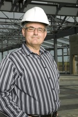 Man In Hardhat In Partially Built Building