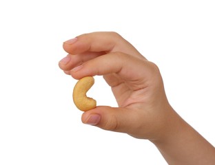 Child's hand holding a cashew