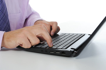 Hands on the laptop keyboard.