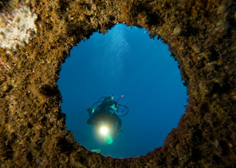 Diver with underwater light  through window
