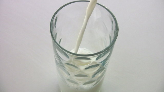 Filling milk into a glass