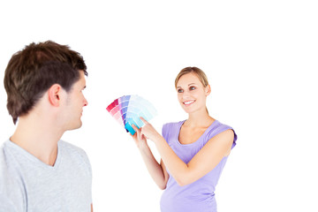 Concentrated young couple choosing color for a room