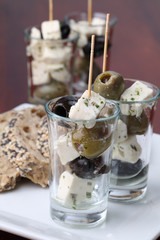 Greek appetizers with black and green olives and feta cheese