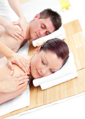 Obraz na płótnie Canvas Attractive young couple receiving a back massage