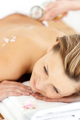 Obraz na płótnie Canvas Pretty young woman enjoying a back massage with oil