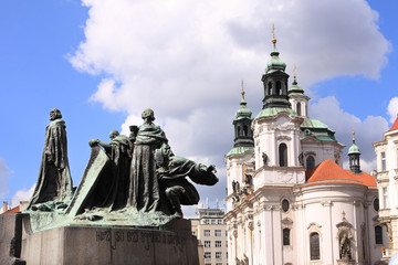 Baroque St. Nicholas' Cathedral in Prague with monument Jan Hus