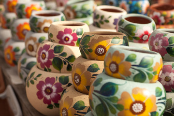 Fototapeta na wymiar Variety of Colorfully Painted Ceramic Pots.