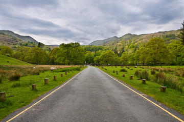 Road in a beautiful ladscape in Lake District, United Kingdom. S