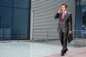 A young business man is talking on the phone