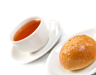 Tea cup and bun against