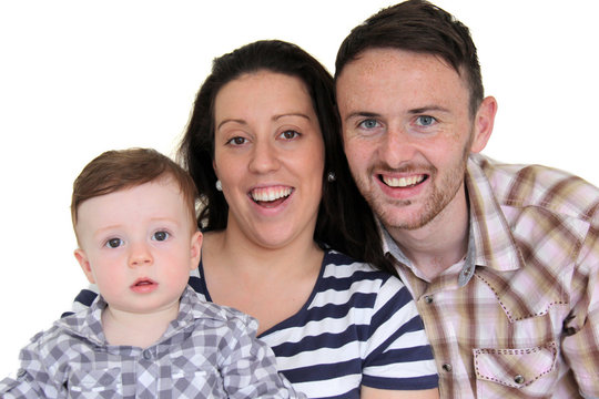 Happy Father, Mother And Toddler Looking At Camera