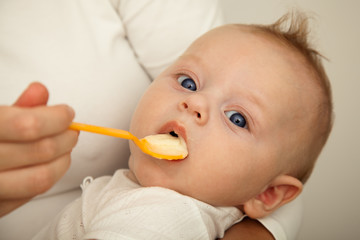 Mother feeding newborn son