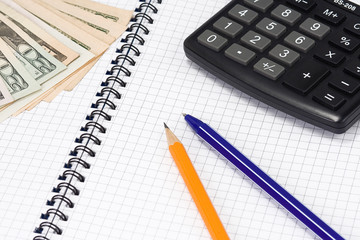 pens and calculator on pad
