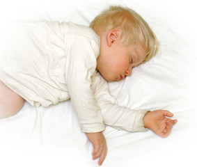 Little boy sleeping in white bedclothes