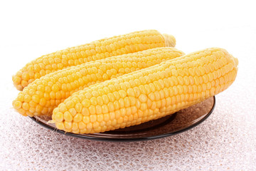Tasty boiled yellow corn on the table