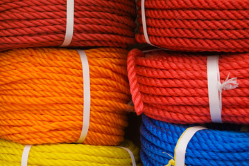 Bundles of colorful ropes stacked for sale in a store in Deira, Dubai, United Arab Emirates