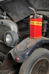 Vintage retro gas can isolated on old car