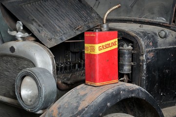 Vintage retro gas can isolated on old car