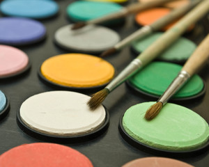 watercolor paints and paint brush