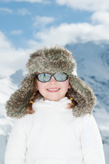 Happy little girl in winter resort