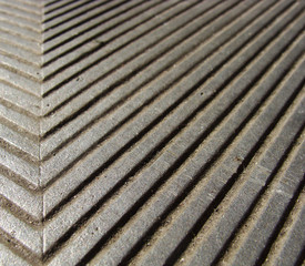 worn metal grid on a sidewalk