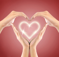 love symbol by hand in the red background