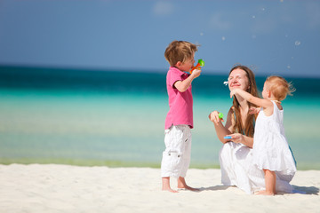 Mother and kids having fun on beach