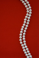 Pearl necklace on red  velvet