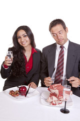 Couple eating him looking at her food