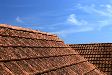 Old tiled roof and beautiful blue sky.