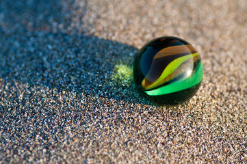Marble on sand
