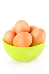 Some brown hen's eggs in the plate isolated on white