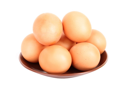 Group of brown hen's eggs in the plate isolated on white