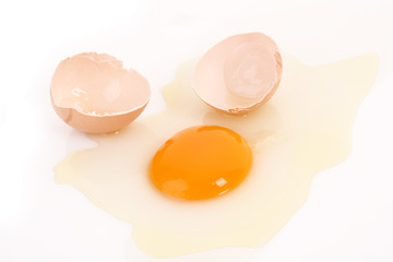 One cracked hen's egg isolated on white