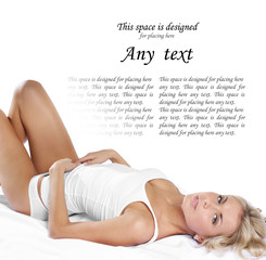 A young blond girl is laying on a white silk blanket