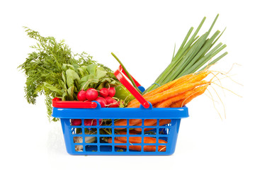 Shopping basket with vegetables over white background