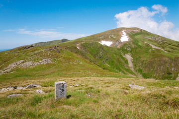 Fototapeta na wymiar stony post on summer mountain ridge