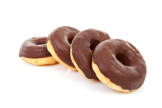 delicious chocolate donuts over white background