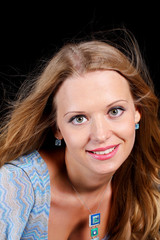 a charming young blonde on a black background